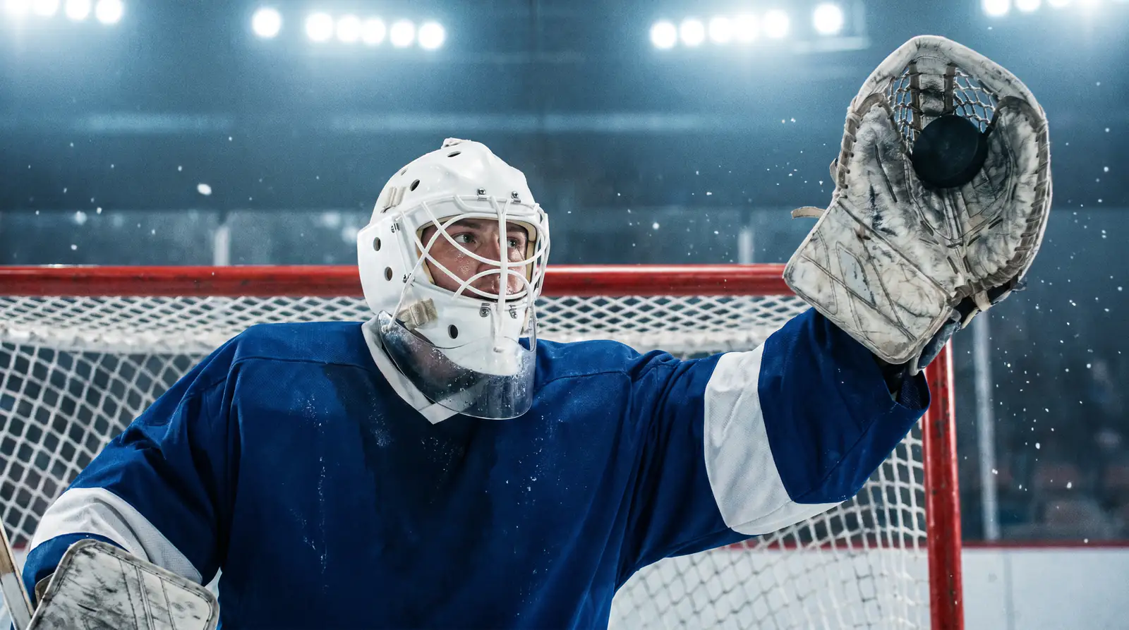 NHL goaltender making a glove save in close on a low-scoring defensive game