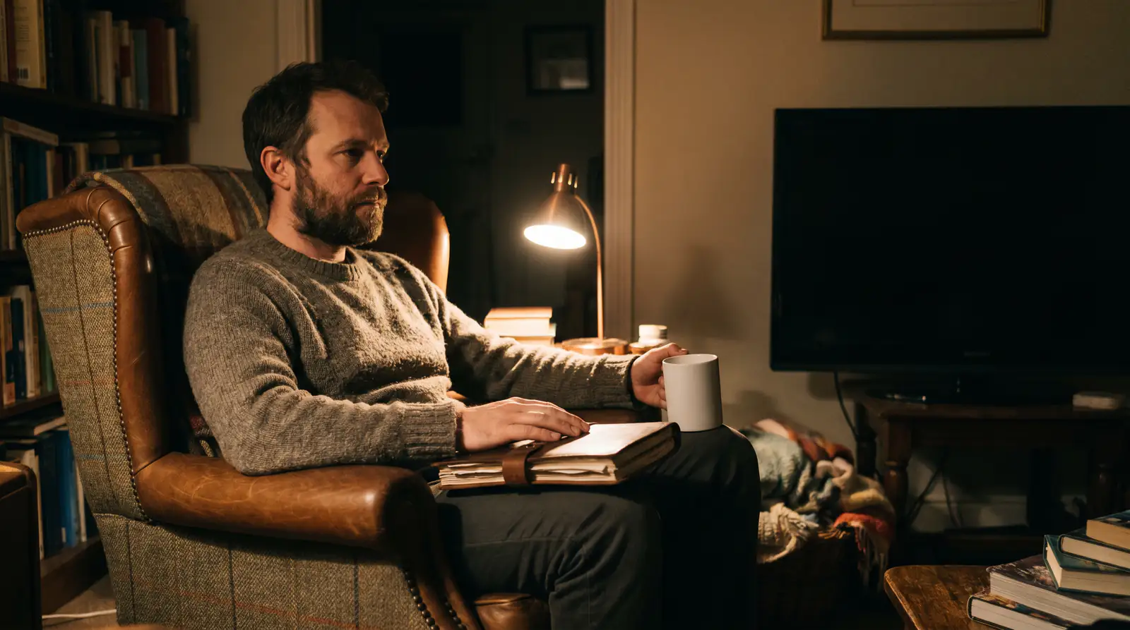 UK bettor's night routine with a cup of tea and a notebook in an armchair