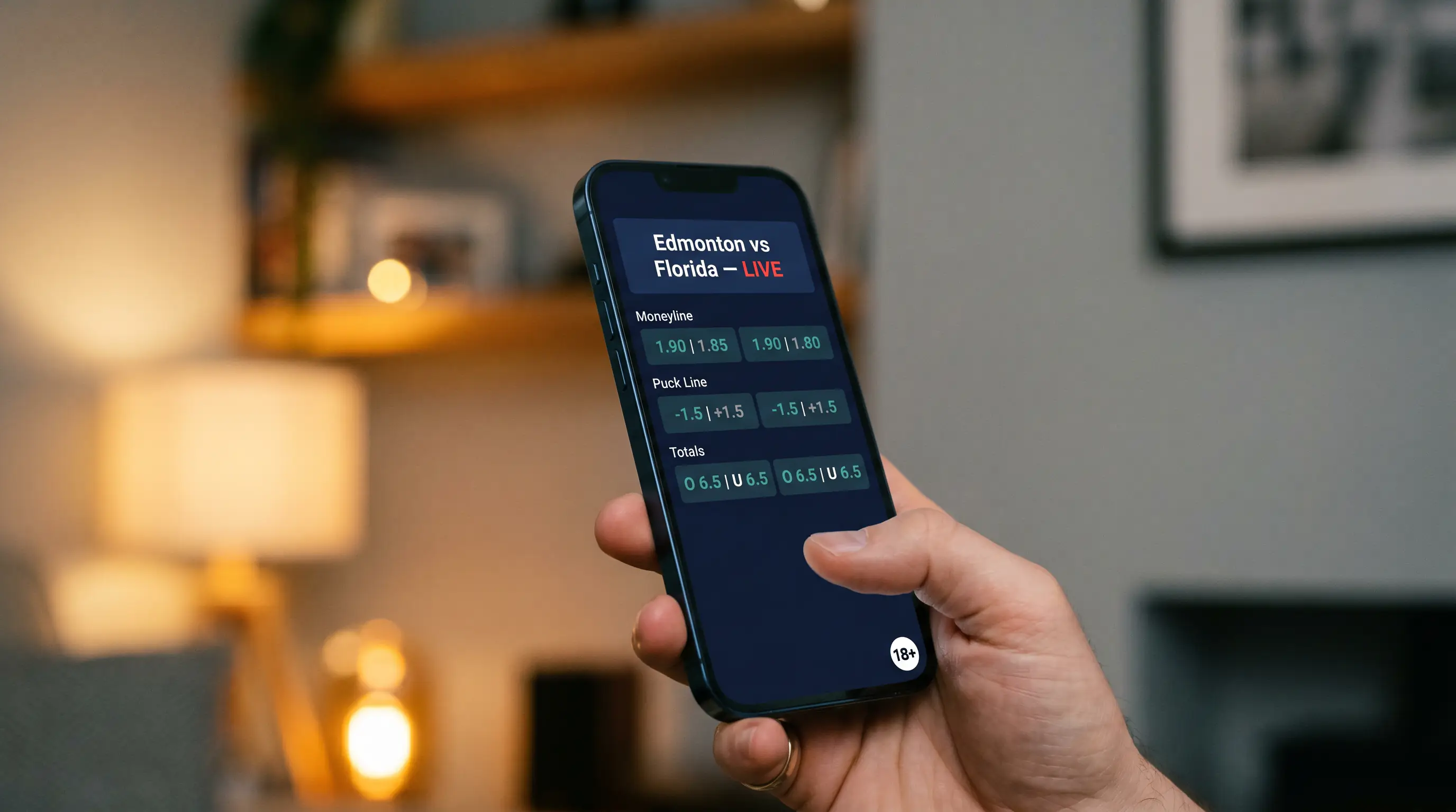 Person holding a smartphone showing a sports betting application with an NHL match card visible, illustrating how UK punters access UKGC-licensed bookmakers from a mobile device.