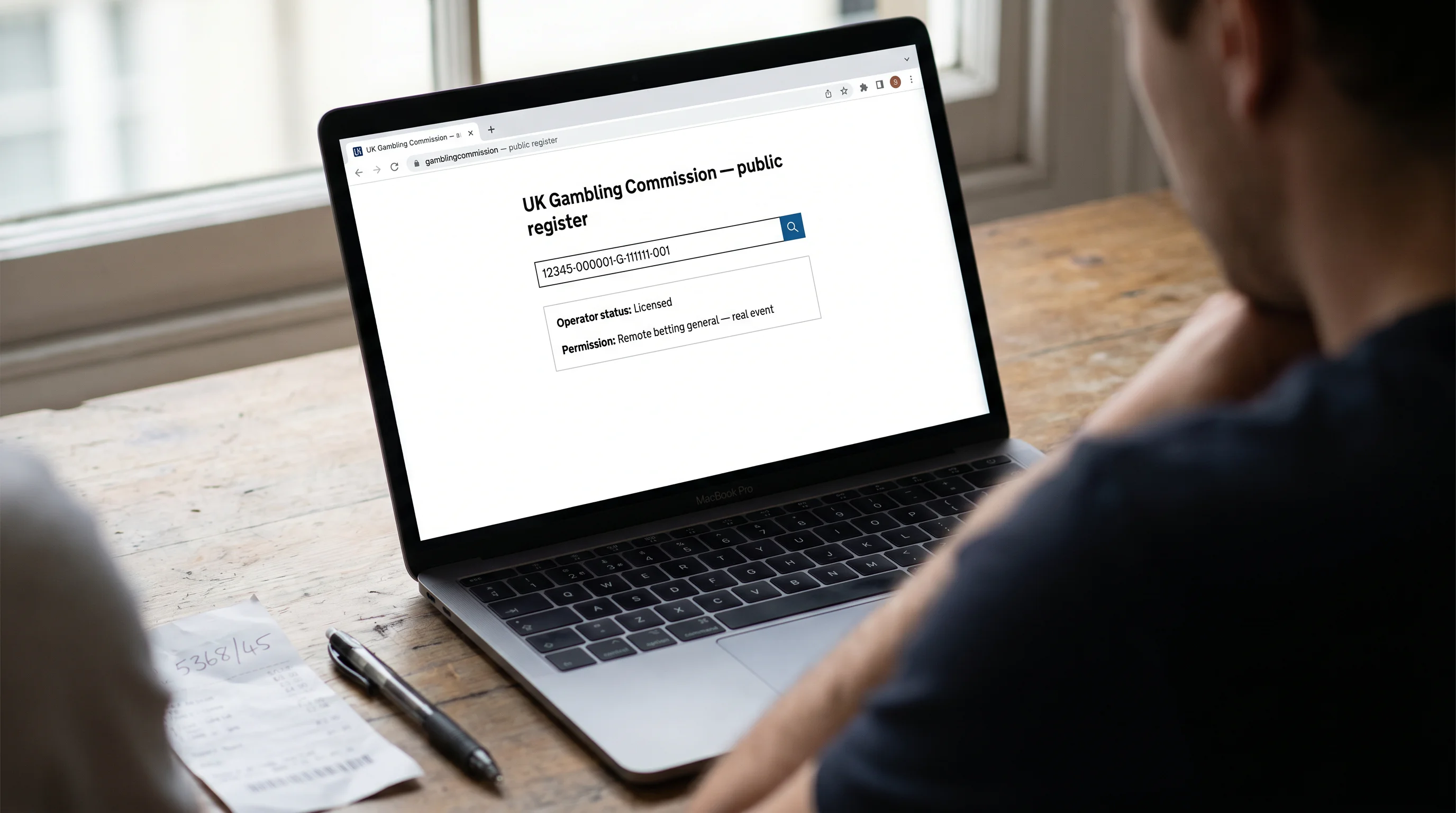 Open laptop displaying a licence verification register page used to check a UKGC-licensed sportsbook